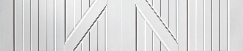 White Carriage House garage door with arched top and diagonal cross-buck panels.