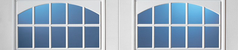 White garage door window with an arched top, 8-pane grid, and blue-tinted glass.